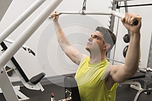 Man Exercising With Pulley In Gym