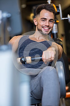 man exercising on rowing machine