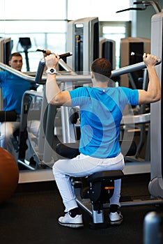 Man exercising on a simulator for dorsi