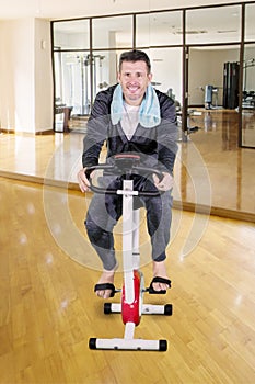 Man exercising on a spin bike in fitness center