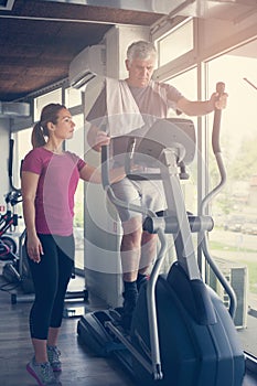 Man exercising on stationary bikes in fitness class. Man