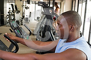 Man Exercising On Stationary Cycle