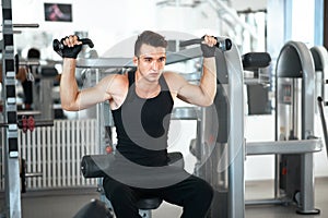 Man exercising in trainer for dorsi muscles