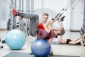 Man exercising with trainer at the rehabilitaion gym