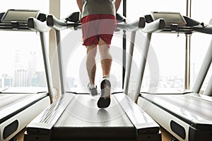 Man exercising on treadmill in gym