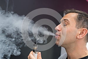 Man exhaling vapor from electronic cigarette