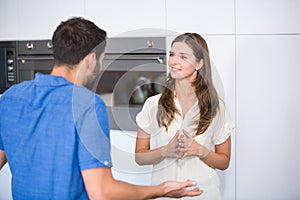 Man explaining wife in kitchen
