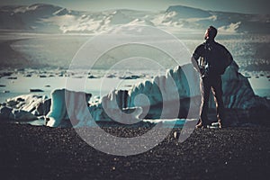 Man explorer lookig at Jokulsarlon lagoon, Iceland.