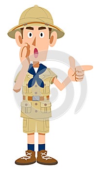 Man in explorer\'s clothes pointing and whispering