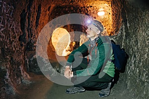 Man exploring caves in Derinkuyu underground city photo