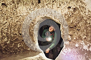 Man exploring caves in Derinkuyu underground city photo