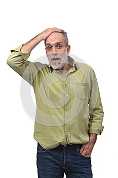 Man with expression of forgetfulness or surprise on white background photo