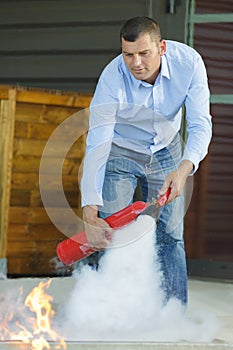 man extinguishing controlled fire during training exercise