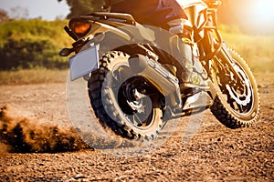 Man extreme riding touring enduro motorcycle on dirt field