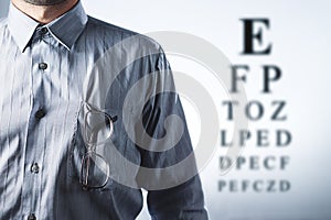 Man with eyeglasses. Eye chart