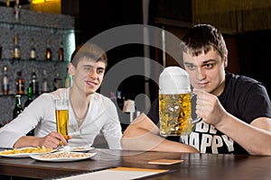Man eyeing a large tankard of beer in anticipation