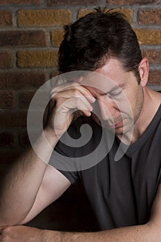 Man with Eyes Closed Rests on Arm