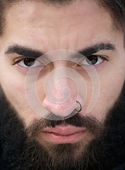 Man face with beard and nose piercing