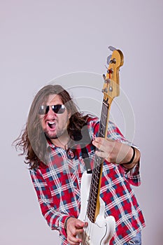 Man with face expression playing electric bass guitar