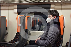 Man with face mask sitting in the train