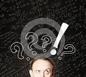 Man face with question mark on blackboard science background. Education, student exam and brainstorm concept