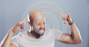 Man, face and rock hand or energy head bang for dance music, heavy metal on grey background. Male person, emoji gesture