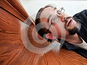 Man Fallen on Stairs Looking Upwards in Shock