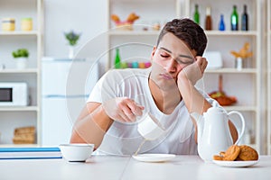 The man falling asleep during his breakfast after overtime work