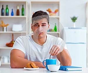 Man falling asleep during his breakfast after overtime work