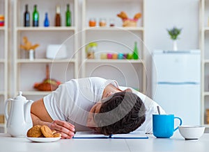 Man falling asleep during his breakfast after overtime work