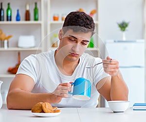 Man falling asleep during his breakfast after overtime work