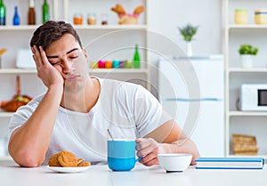 Man falling asleep during his breakfast after overtime work