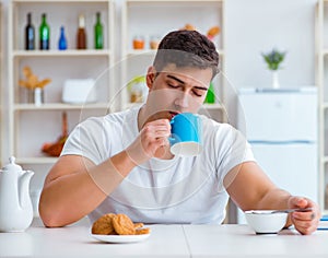 Man falling asleep during his breakfast after overtime work