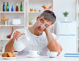 Man falling asleep during his breakfast after overtime work