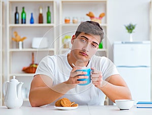 Man falling asleep during his breakfast after overtime work