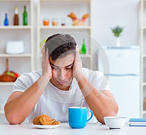 Man falling asleep during his breakfast after overtime work