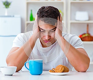 Man falling asleep during his breakfast after overtime work