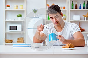 The man falling asleep during his breakfast after overtime work