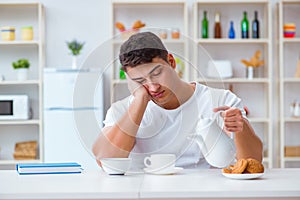 The man falling asleep during his breakfast after overtime work