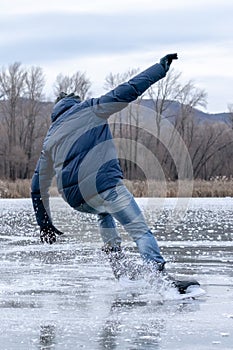 Man falling down while ice skating. Snow skates from the scatter in the parties