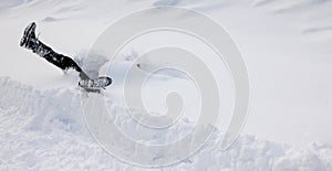 Man is falling headfirst into deep snow. Concept of winterly slippery conditions. photo