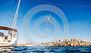 Man falling from zipline on mast of boat