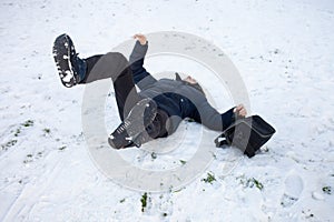 A man falls in the snow. The man slipped and was injured. Falling on ice. Winter. Fracture, bruise, dislocation