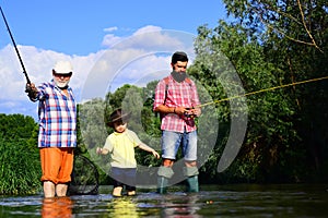 Man family fishing. Boy with father and grandfather fly fishing outdoor over river background. Old and young. Father and