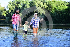 Man family fishing. Father, son and grandfather relaxing together. Grandfather and father with cute child boy are