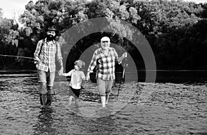 Man family fishing. Father, son and grandfather relaxing together. Grandfather and father with cute child boy are