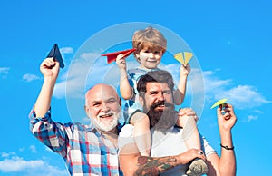 Man family. Freedom to dream. Kid playing with airplane against the sky. Happy grandfather father and grandson son with