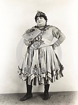 Man with fan dressed in women's clothing, 1920s