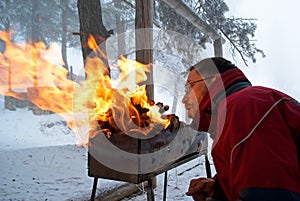 Man fanning fire in grill