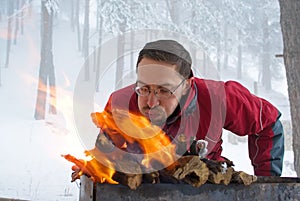 Man fanning fire in grill